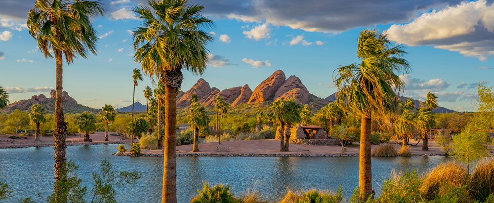The lake and trees surrounding Papago Park in Tempe, Arizona, offer stunning views and a great place to enjoy the mild climate.